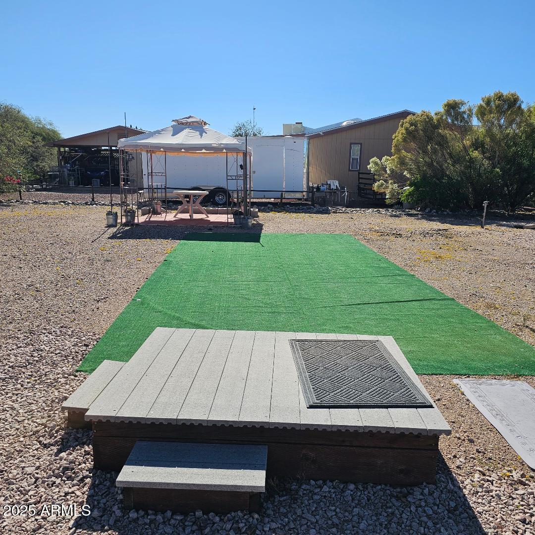 30605 Meandering Lane, Unit 151 Congress, AZ 85332 - Photo 15 of 18 a view of a patio with a table and chairs