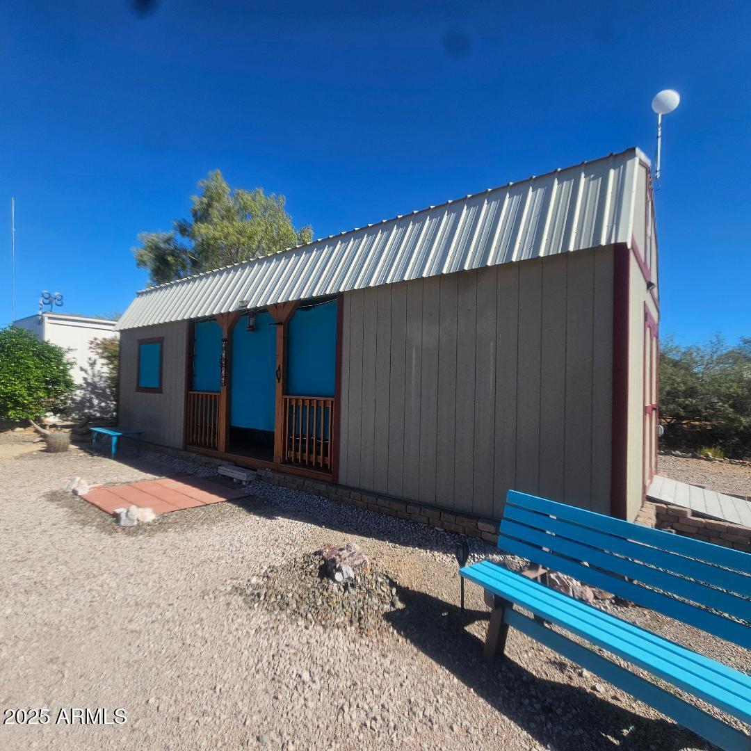 30605 Meandering Lane, Unit 151 Congress, AZ 85332 - Photo 6 of 18 a view of a house with a wooden bench