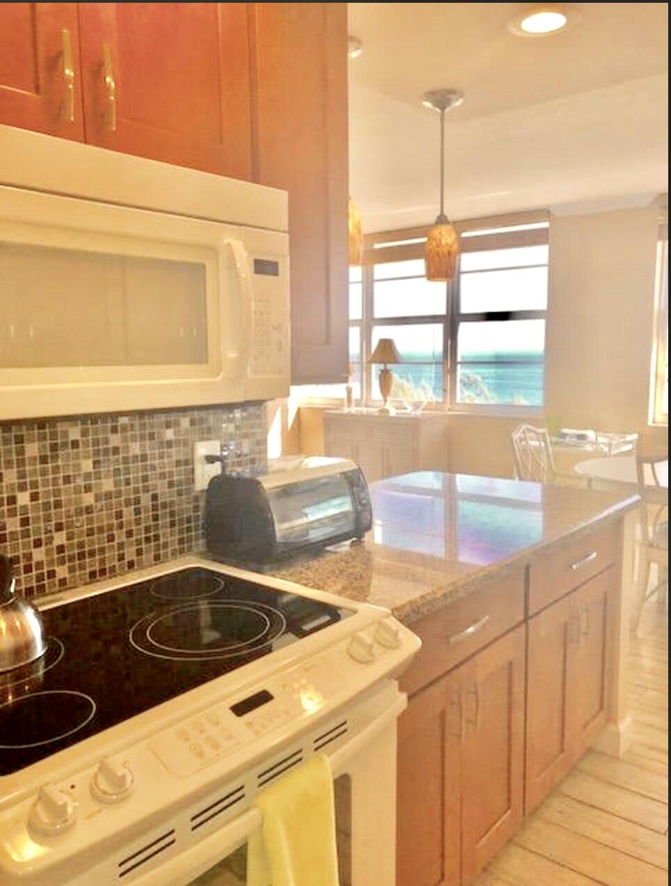 2121 North Ocean Boulevard, Unit 1208E Boca Raton, FL 33431 - Photo 11 of 61 a kitchen with a sink and large window