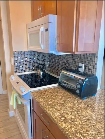a kitchen with cabinets and wooden floor