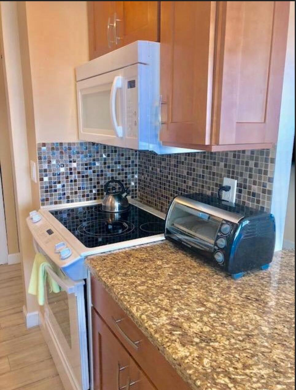 2121 North Ocean Boulevard, Unit 1208E Boca Raton, FL 33431 - Photo 12 of 61 a kitchen with a stove and a sink