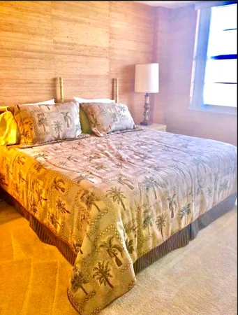 a bedroom with a bed and a flat tv screen in it