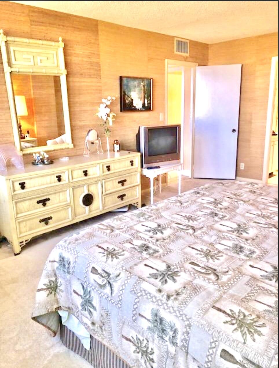 2121 North Ocean Boulevard, Unit 1208E Boca Raton, FL 33431 - Photo 18 of 61 a bedroom with a bed and a flat tv screen in it