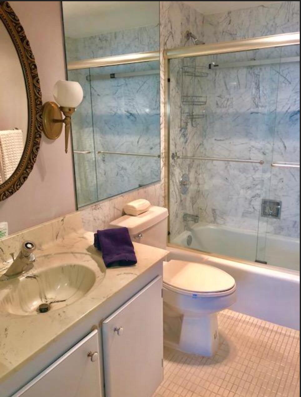 2121 North Ocean Boulevard, Unit 1208E Boca Raton, FL 33431 - Photo 19 of 61 a bathroom with a sink and a mirror