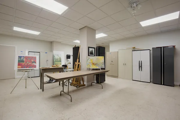 a large white kitchen with a large window and stainless steel appliances