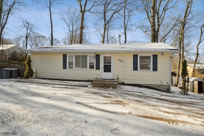 a view of a house with a snow on the road