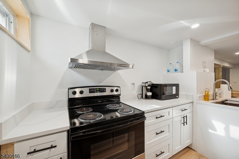206 Brooklyn Mountain Road Hopatcong, NJ 07843 - Photo 14 of 18 a kitchen with granite countertop stainless steel appliances and white cabinets