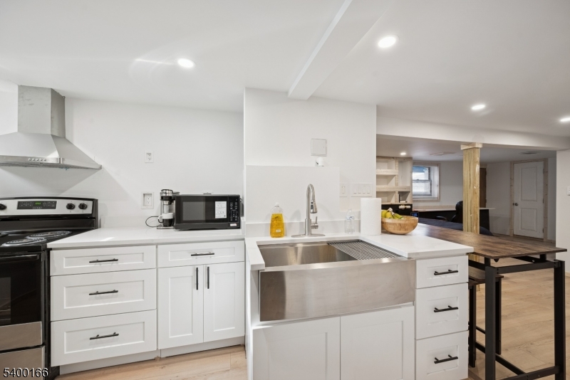 206 Brooklyn Mountain Road Hopatcong, NJ 07843 - Photo 15 of 18 a kitchen with white cabinets and appliances
