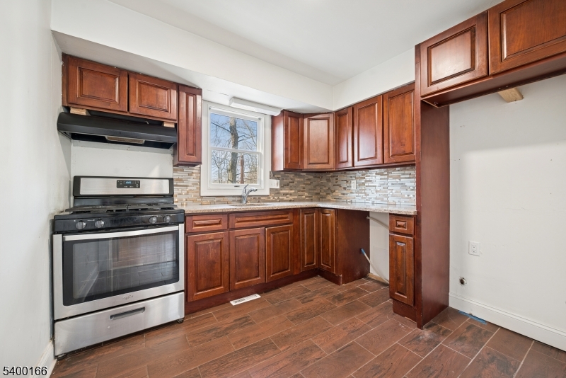 206 Brooklyn Mountain Road Hopatcong, NJ 07843 - Photo 2 of 18 a kitchen with granite countertop a stove cabinets and microwave