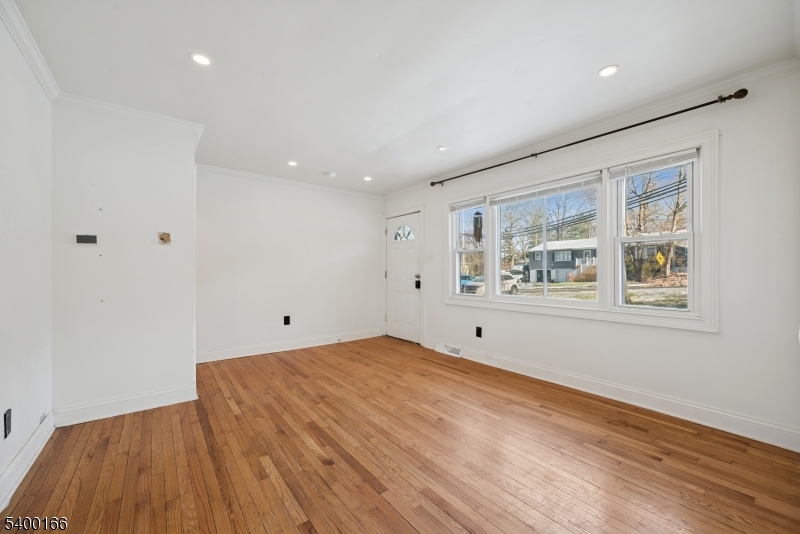 206 Brooklyn Mountain Road Hopatcong, NJ 07843 - Photo 7 of 18 a view of empty room with wooden floor and fan