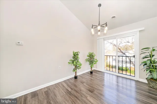 a view of an entryway with wooden floor