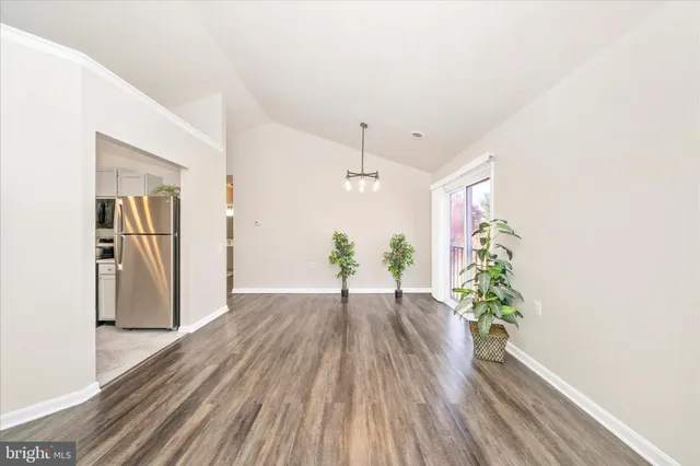 a view of a hallway with wooden floor and glass door