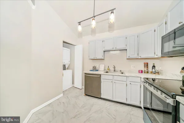 a kitchen with a sink a stove and cabinets