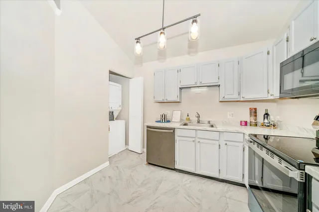 a kitchen with a sink a stove and cabinets