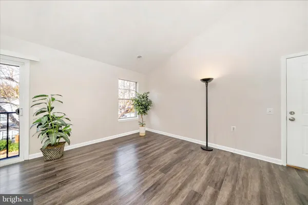 a view of an empty room and wooden floor