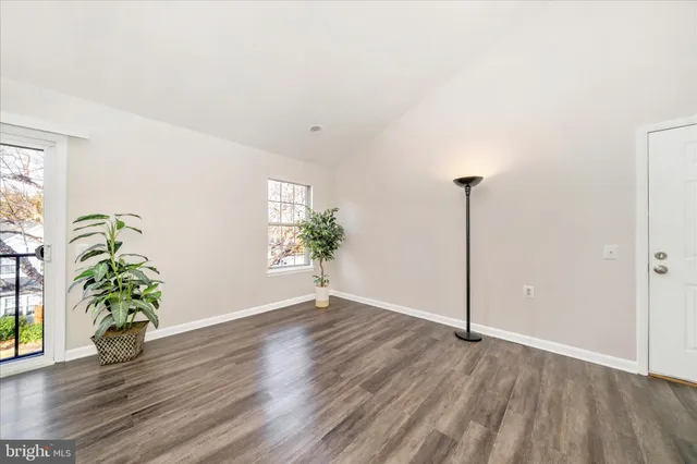 a view of an empty room and wooden floor