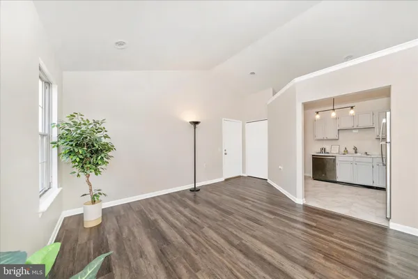 a view of a room with wooden floor and a potted plant