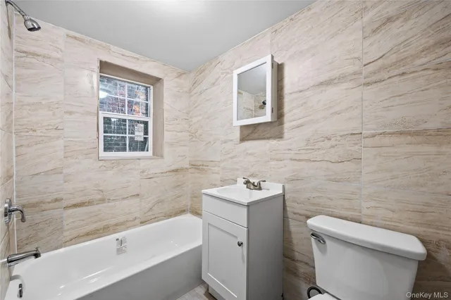 a bathroom with a sink a toilet and bathtub