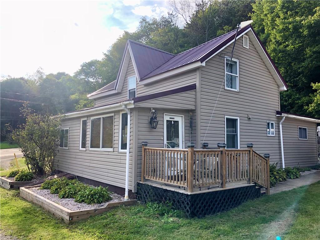 a view of a house with a yard and deck