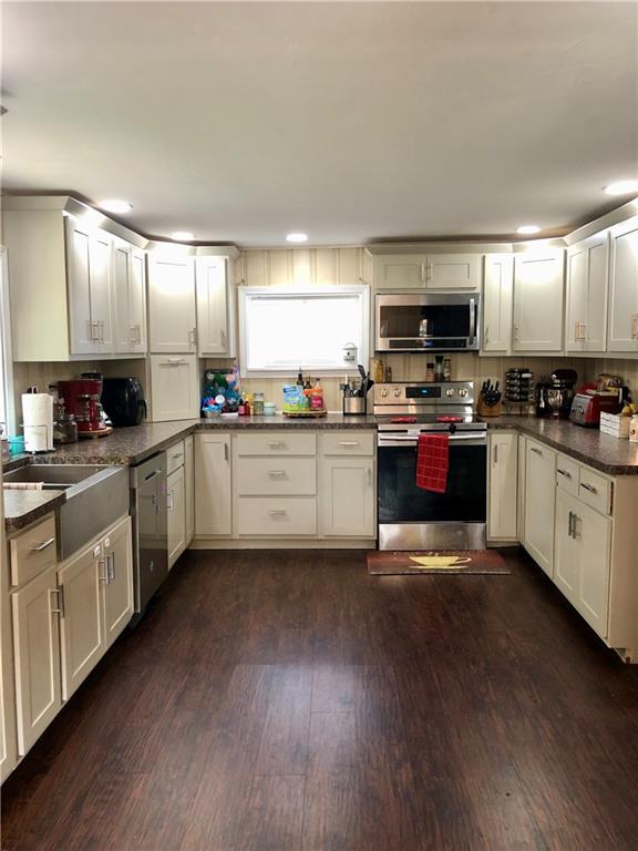 203 Lighthouse Road Commodore, PA 15729 - Photo 4 of 16 a kitchen with cabinets a sink and appliances