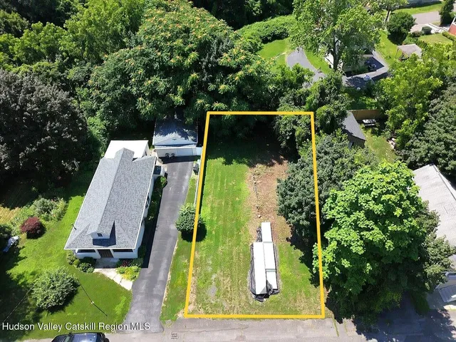 an aerial view of a house with a yard basket ball court and outdoor seating