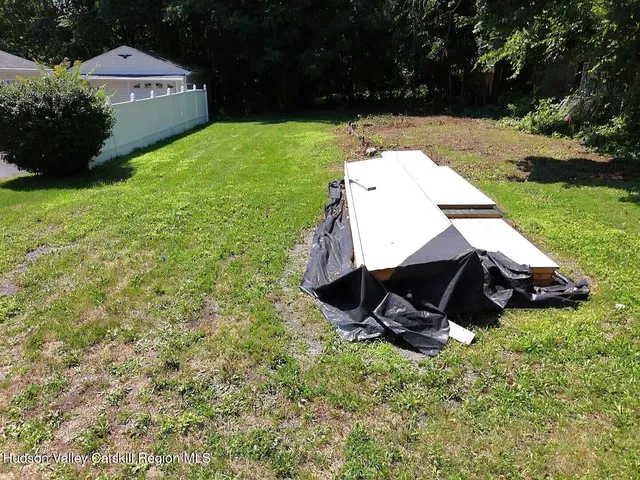 a view of a backyard with sitting area