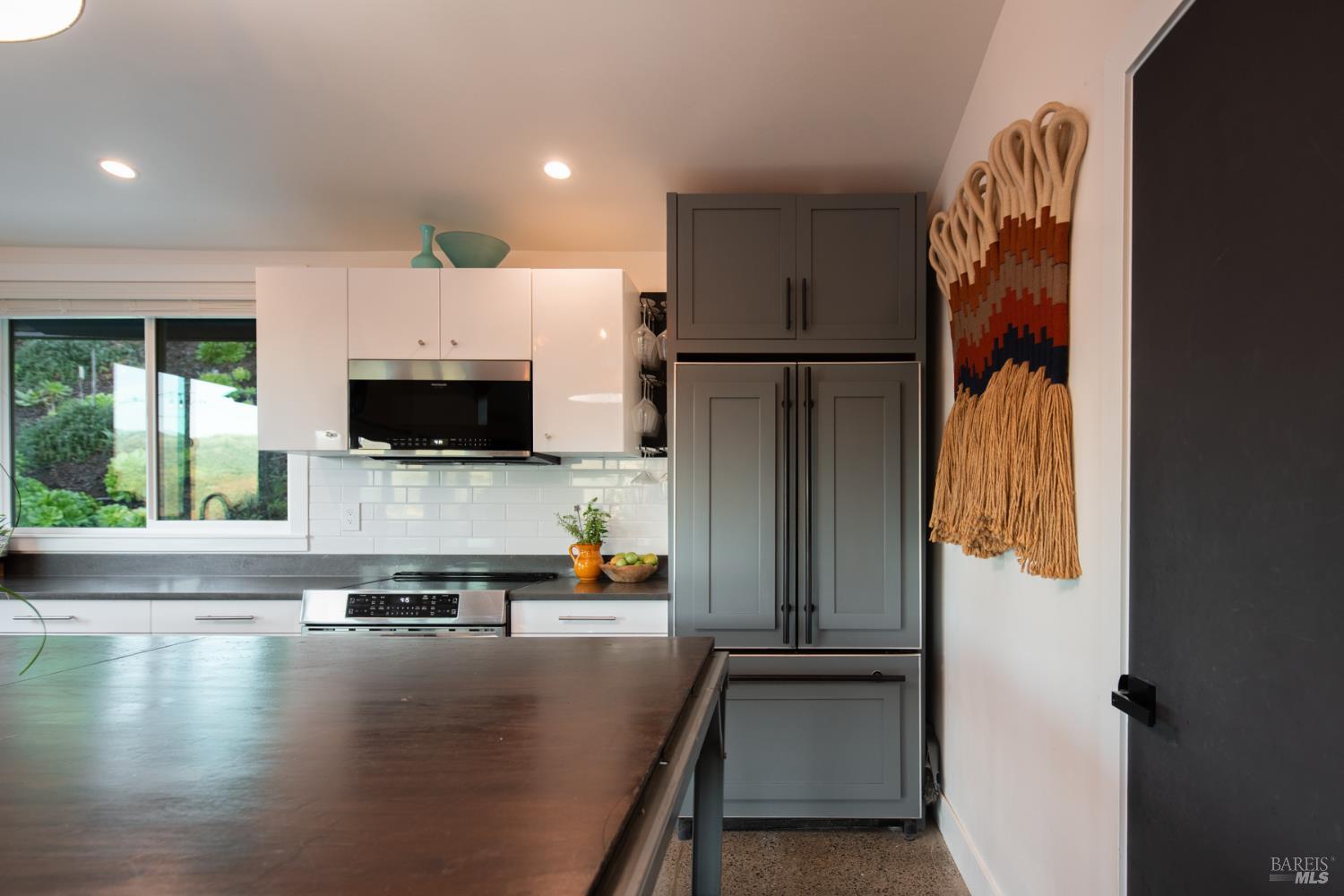 22855 Chianti Road Geyserville, CA 95411 - Photo 12 of 76 a view of a kitchen with flat screen tv and refrigerator