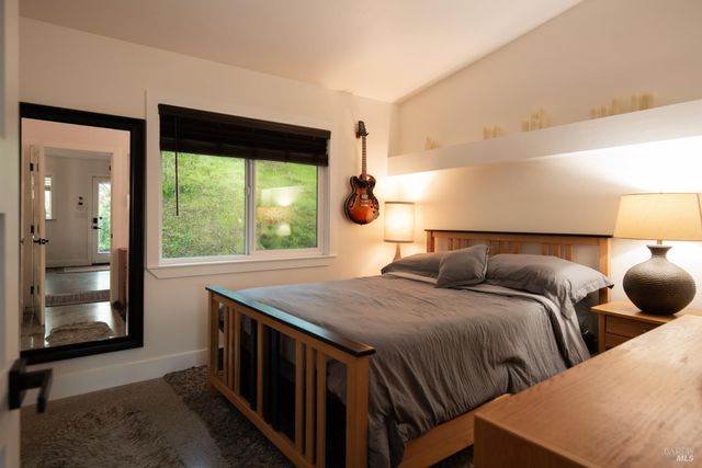 a backyard of a house with potted plants and large trees