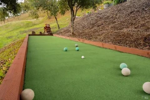 a dining room with stainless steel appliances kitchen island granite countertop furniture and a wooden floor