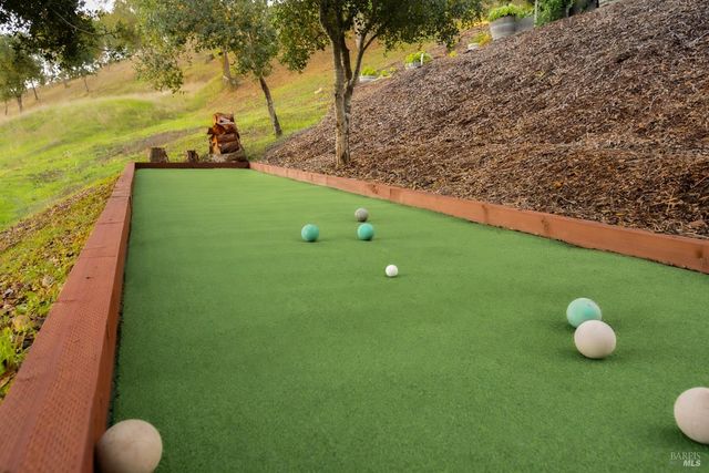 a dining room with stainless steel appliances kitchen island granite countertop furniture and a wooden floor