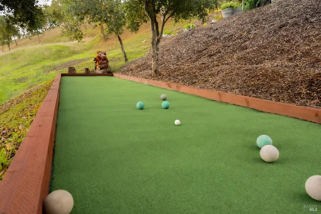 a dining room with stainless steel appliances kitchen island granite countertop furniture and a wooden floor