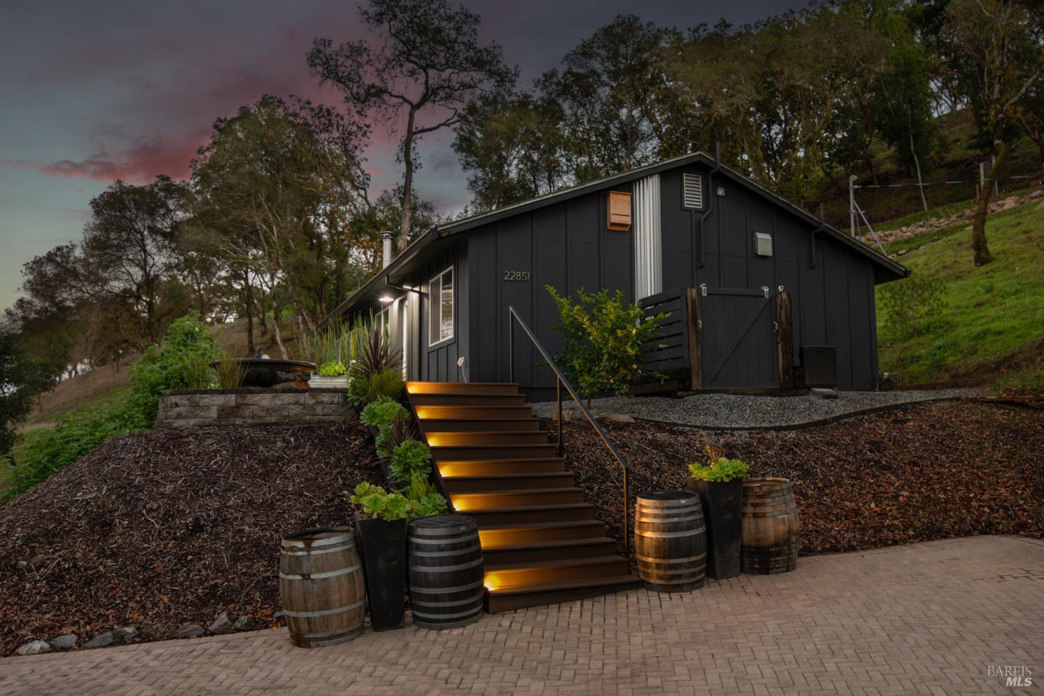 22855 Chianti Road Geyserville, CA 95411 - Photo 24 of 76 a backyard of a house with potted plants and large trees