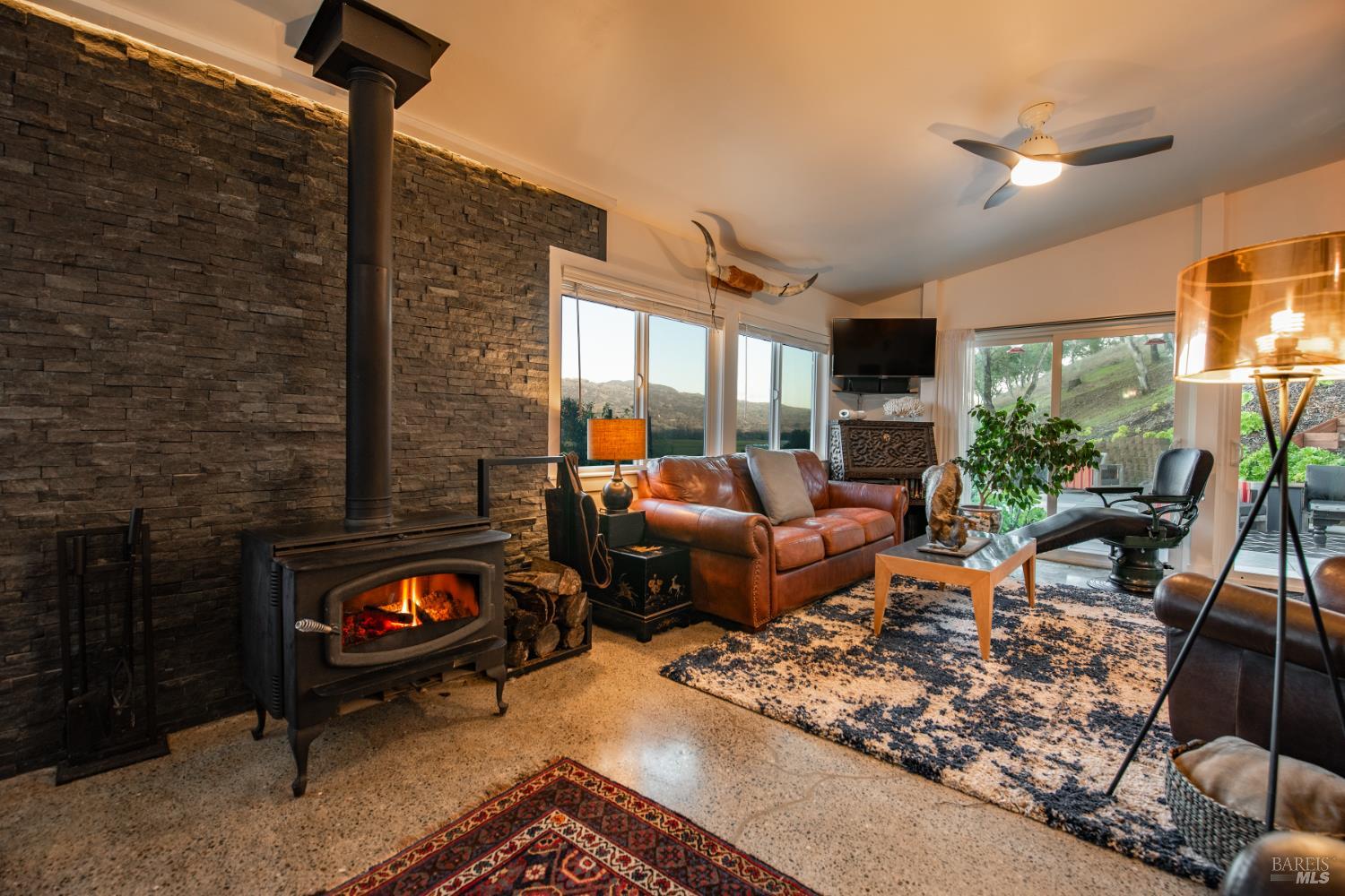 22855 Chianti Road Geyserville, CA 95411 - Photo 5 of 76 a living room with furniture a rug and a floor to ceiling window