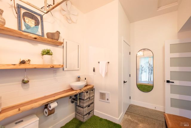 a view of a livingroom with workspace and a window