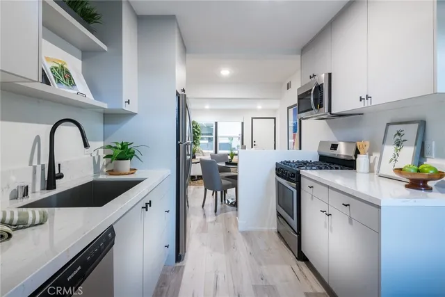 a living room with furniture a window and a potted plant