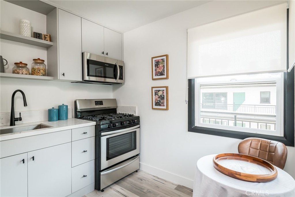 262 North Los Robles Avenue Pasadena, CA 91101 - Photo 29 of 45 a kitchen with stainless steel appliances granite countertop a stove a sink and a microwave