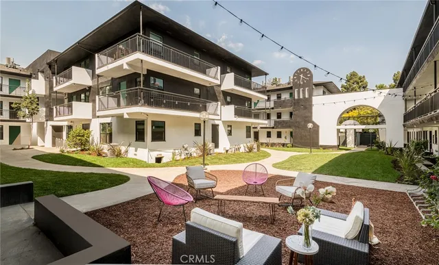 a front view of a house with swimming pool having outdoor seating