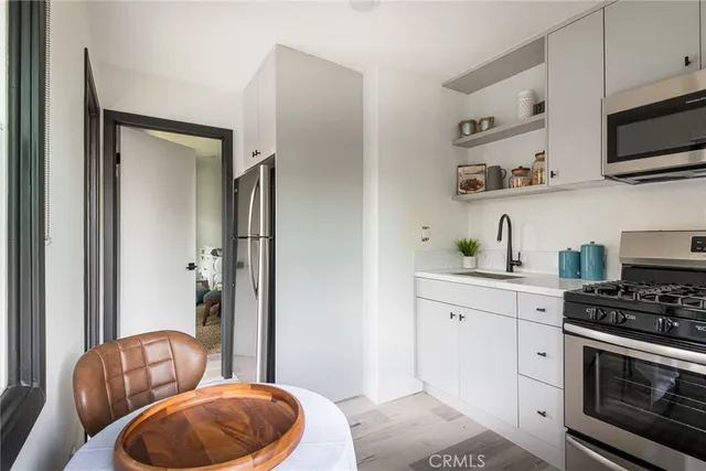 a utility room with a window dryer and cabinets