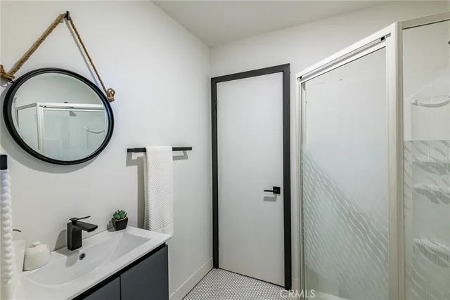 a kitchen with a sink wooden floor and stainless steel appliances