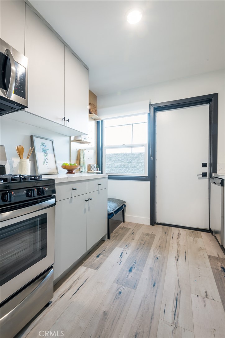 262 North Los Robles Avenue Pasadena, CA 91101 - Photo 40 of 45 a kitchen with a sink wooden floor and stainless steel appliances