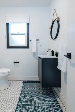 a bedroom with a bed and a wooden floor