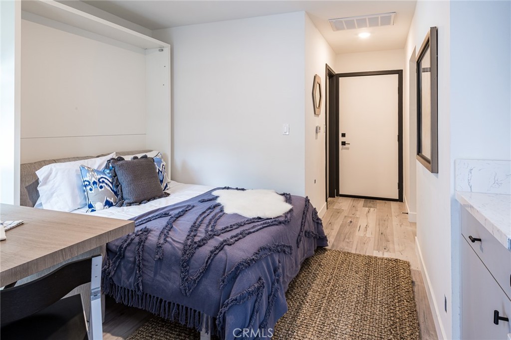 262 North Los Robles Avenue Pasadena, CA 91101 - Photo 45 of 45 a bedroom with a bed and a wooden floor