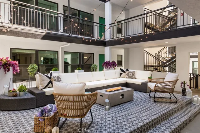 a view of a patio with couches table and chairs and potted plants