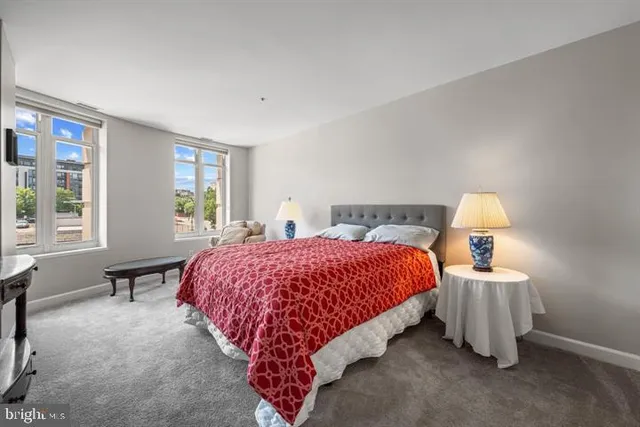 a spacious bedroom with a bed and a window