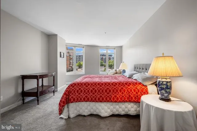 a bedroom with a bed and a lamp