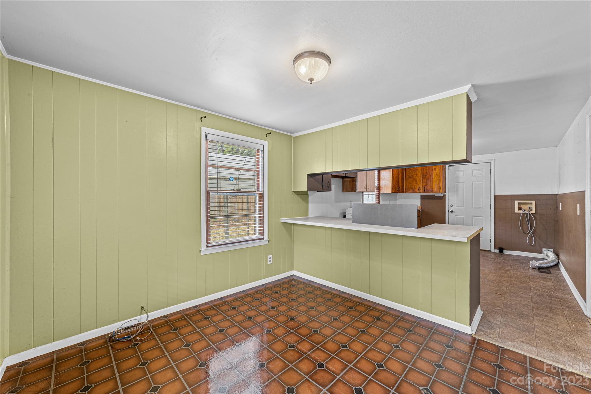 5641 Anderson Road Charlotte, NC 28269 - Photo 11 of 27 a view of a kitchen with fridge and a window