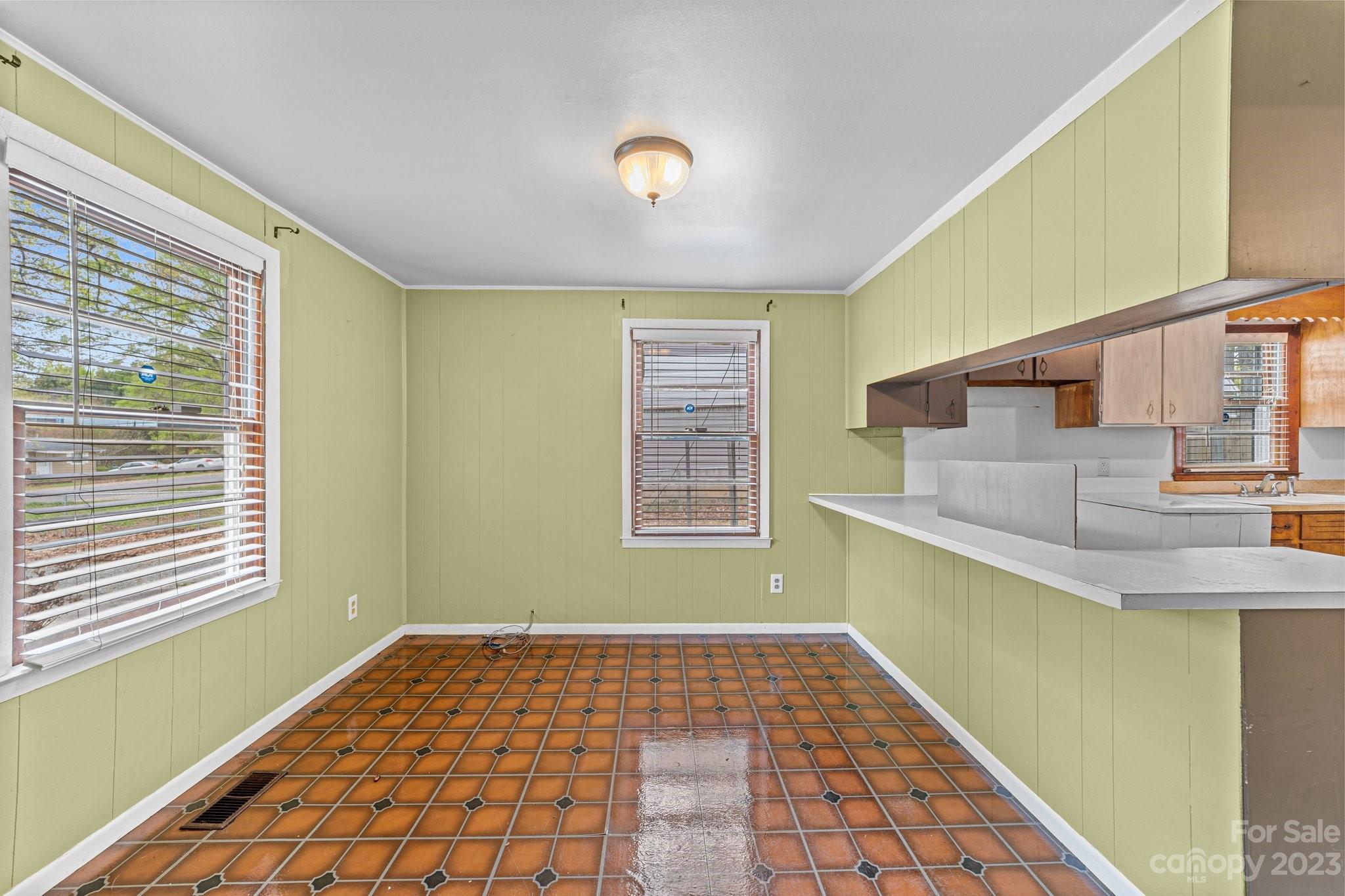5641 Anderson Road Charlotte, NC 28269 - Photo 12 of 27 a view of an empty room with window and wooden floor