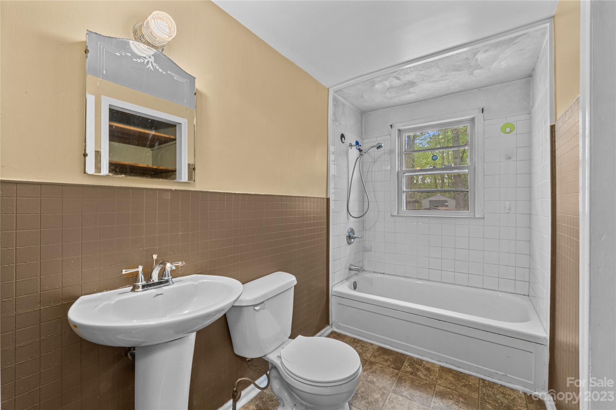 5641 Anderson Road Charlotte, NC 28269 - Photo 16 of 27 a bathroom with a sink toilet and shower