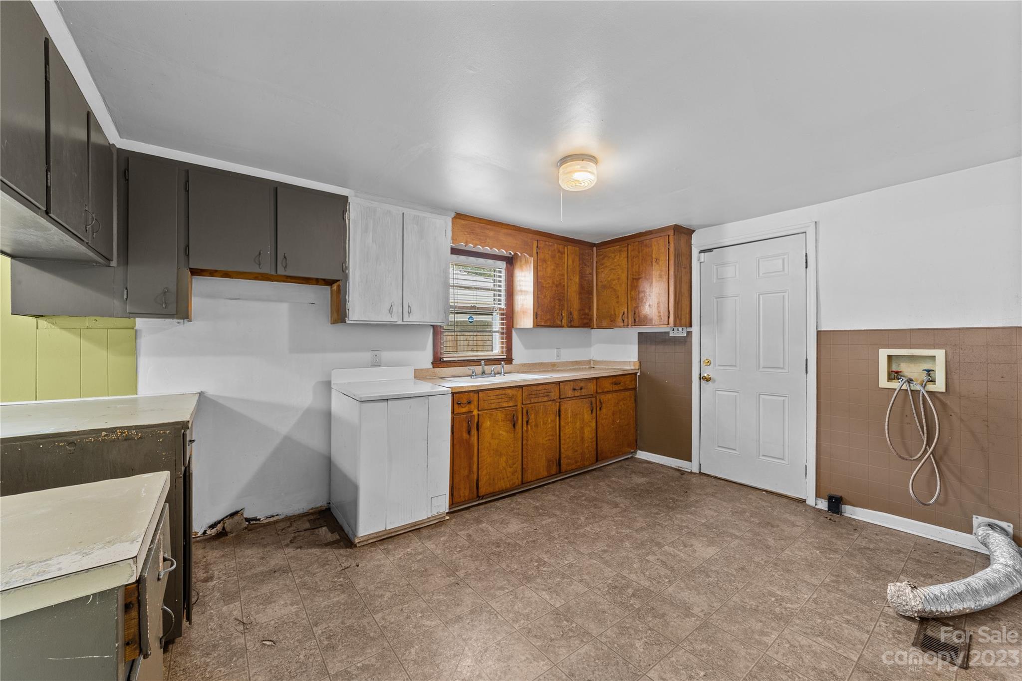 5641 Anderson Road Charlotte, NC 28269 - Photo 9 of 27 a kitchen with sink cabinets and window