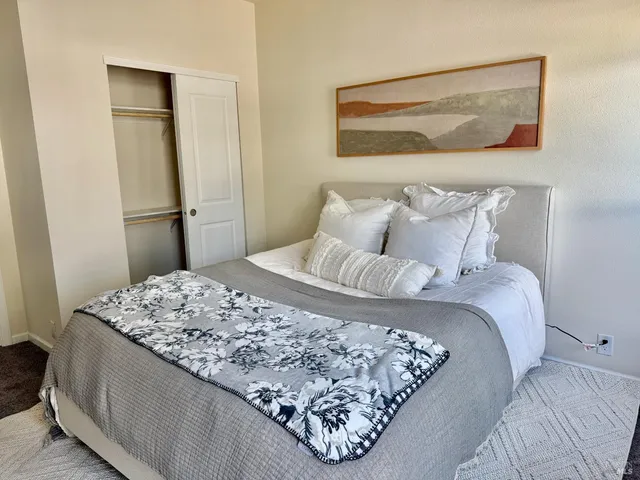 a bedroom with a bed and hallway